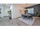 Chic dining room with round table, stylish chairs, modern lighting, and decorative plants at 18233 W Hope Dr, Goodyear, AZ 85338