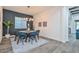 The dining room features stylish decor, an elegant light fixture, and a view into the living space at 18233 W Hope Dr, Goodyear, AZ 85338