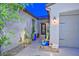 Inviting home entrance with desert landscaping, including cacti in blue pots and a Ring doorbell at 18233 W Hope Dr, Goodyear, AZ 85338