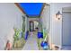 Inviting front entrance featuring stylish potted cacti and a decorative security door at 18233 W Hope Dr, Goodyear, AZ 85338