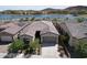 Charming single-story home boasts desert landscaping and a tile roof near a tranquil lake at 18233 W Hope Dr, Goodyear, AZ 85338