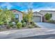 Charming single-story home with desert landscaping, a paved driveway, and an attached garage at 18233 W Hope Dr, Goodyear, AZ 85338