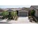 Charming single-story home with a well-kept lawn and a two car garage at 18233 W Hope Dr, Goodyear, AZ 85338
