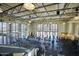The community fitness center includes multiple machines and workout equipment with an abundance of natural light at 18233 W Hope Dr, Goodyear, AZ 85338