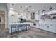 Bright kitchen featuring white cabinetry, stainless steel appliances, quartz countertops, and a large center island at 18233 W Hope Dr, Goodyear, AZ 85338