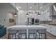 Bright modern kitchen with white cabinetry, a large island, stainless steel appliances, and stylish pendant lights at 18233 W Hope Dr, Goodyear, AZ 85338