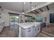 Open-concept kitchen with a large center island, farmhouse sink, pendant lighting, and high-end appliances at 18233 W Hope Dr, Goodyear, AZ 85338