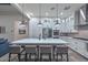 Modern kitchen with a large island, seating, stainless steel appliances, and pendant lighting at 18233 W Hope Dr, Goodyear, AZ 85338