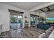 Open concept living room with views of the pool, access to the patio, and modern furnishings at 18233 W Hope Dr, Goodyear, AZ 85338