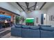Living room with high ceilings, wood beams, and an inviting view of the outdoor patio at 18233 W Hope Dr, Goodyear, AZ 85338