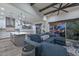 Open-concept living room with vaulted ceilings, exposed wood beams, and seamless indoor/outdoor living at 18233 W Hope Dr, Goodyear, AZ 85338
