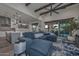 Spacious living area boasts an open floor plan, connecting the kitchen and living spaces, with an inviting blue sectional sofa at 18233 W Hope Dr, Goodyear, AZ 85338