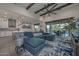 Open-concept living room with vaulted ceilings, ceiling fan, and access to the outdoor pool area at 18233 W Hope Dr, Goodyear, AZ 85338