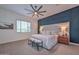 Stunning main bedroom featuring a gray bed frame, stylish decor, and an accent wall at 18233 W Hope Dr, Goodyear, AZ 85338