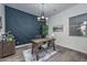 Stylish office with a wooden desk, decorative accent wall, and modern chandelier at 18233 W Hope Dr, Goodyear, AZ 85338