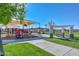 Community park featuring a playground, picnic tables, and grassy areas for recreation at 18233 W Hope Dr, Goodyear, AZ 85338