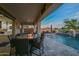 Outdoor patio with a fire pit, swimming pool, and stunning desert views at 18233 W Hope Dr, Goodyear, AZ 85338