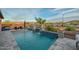 Inviting pool featuring elegant waterfalls, fire bowls, mountain views and lush landscaping at 18233 W Hope Dr, Goodyear, AZ 85338