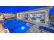 Backyard pool featuring custom waterfalls, fire bowls, a hot tub, and seamless access to indoor living at 18233 W Hope Dr, Goodyear, AZ 85338