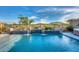 Luxury backyard pool with fountains, stunning lake views and beautiful, drought-tolerant landscaping at 18233 W Hope Dr, Goodyear, AZ 85338