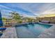 Backyard pool and hot tub with fire features and desert views offer a private oasis at 18233 W Hope Dr, Goodyear, AZ 85338