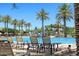 Resort-style pool and water park with ample lounge chairs and palm trees, perfect for relaxation and recreation at 18233 W Hope Dr, Goodyear, AZ 85338