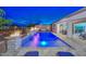 Backyard pool featuring custom waterfalls, fire bowls, a hot tub, and seamless access to indoor living at 18233 W Hope Dr, Goodyear, AZ 85338