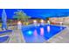 Backyard pool featuring custom waterfalls, fire bowls, a hot tub, and mountain views at 18233 W Hope Dr, Goodyear, AZ 85338