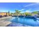 Beautiful pool and deck area with serene lake views and elegant stone accents at 18233 W Hope Dr, Goodyear, AZ 85338