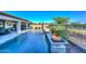 Gorgeous pool with a tranquil waterfront view, fire bowls and plenty of space to relax and unwind at 18233 W Hope Dr, Goodyear, AZ 85338