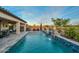 Backyard pool featuring custom waterfalls, fire bowls, and mountain/lake views at 18233 W Hope Dr, Goodyear, AZ 85338