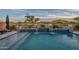 Backyard pool with waterfalls and fire bowls, perfect for outdoor entertaining and enjoying lakeside views at 18233 W Hope Dr, Goodyear, AZ 85338