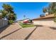 Spacious backyard featuring artificial turf, picnic tables, gravel, and mature trees at 19258 N 20Th Dr, Phoenix, AZ 85027