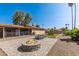 Large backyard featuring a patio, fire pit, artificial turf, and mature landscaping at 19258 N 20Th Dr, Phoenix, AZ 85027