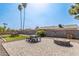 Spacious backyard with a brick patio, fire pit, artificial turf, and mature landscaping at 19258 N 20Th Dr, Phoenix, AZ 85027