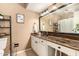 Bright bathroom featuring granite countertops, a large mirror, and decorative accents, enhancing the space's appeal at 19258 N 20Th Dr, Phoenix, AZ 85027