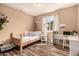 This bedroom features a twin bed, a study desk and hardwood floor at 19258 N 20Th Dr, Phoenix, AZ 85027