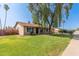 Single story home featuring lush green lawn, mature landscaping and desert flora, and a two car garage at 19258 N 20Th Dr, Phoenix, AZ 85027