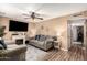 Cozy living room with modern furnishings, a ceiling fan, wood laminate flooring, and plenty of natural light at 19258 N 20Th Dr, Phoenix, AZ 85027