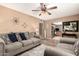 Open living room with modern furnishings, wood laminate flooring, and seamless view into dining and kitchen at 19258 N 20Th Dr, Phoenix, AZ 85027