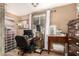 Functional home office space with natural light, a desk, a rolling chair, and storage, ideal for productivity at 19258 N 20Th Dr, Phoenix, AZ 85027