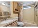Small bathroom with a shower-tub combo, granite counter, and matching cabinets at 1939 E Libby St, Phoenix, AZ 85022