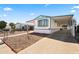 Exterior shot with covered awning and long driveway for parking, surrounded by desert landscaping at 1939 E Libby St, Phoenix, AZ 85022