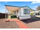The front of the home features a covered awning, tiled walkway, and green front porch at 1939 E Libby St, Phoenix, AZ 85022