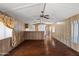 Spacious living room area with laminate floors and a ceiling fan at 1939 E Libby St, Phoenix, AZ 85022