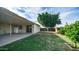 Spacious backyard with covered patio, mature tree, and room for outdoor activities at 2002 S Apache Dr, Apache Junction, AZ 85120