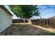 This backyard has a mature tree and wooden fence at 2002 S Apache Dr, Apache Junction, AZ 85120