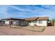 Charming single-story home featuring a carport, one-car garage, and traditional-style windows at 2002 S Apache Dr, Apache Junction, AZ 85120