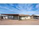 Charming single-story home featuring a carport, one-car garage, and traditional-style windows at 2002 S Apache Dr, Apache Junction, AZ 85120