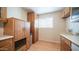 Functional kitchen featuring wood cabinets, laminate countertops, and a window for natural light at 2002 S Apache Dr, Apache Junction, AZ 85120